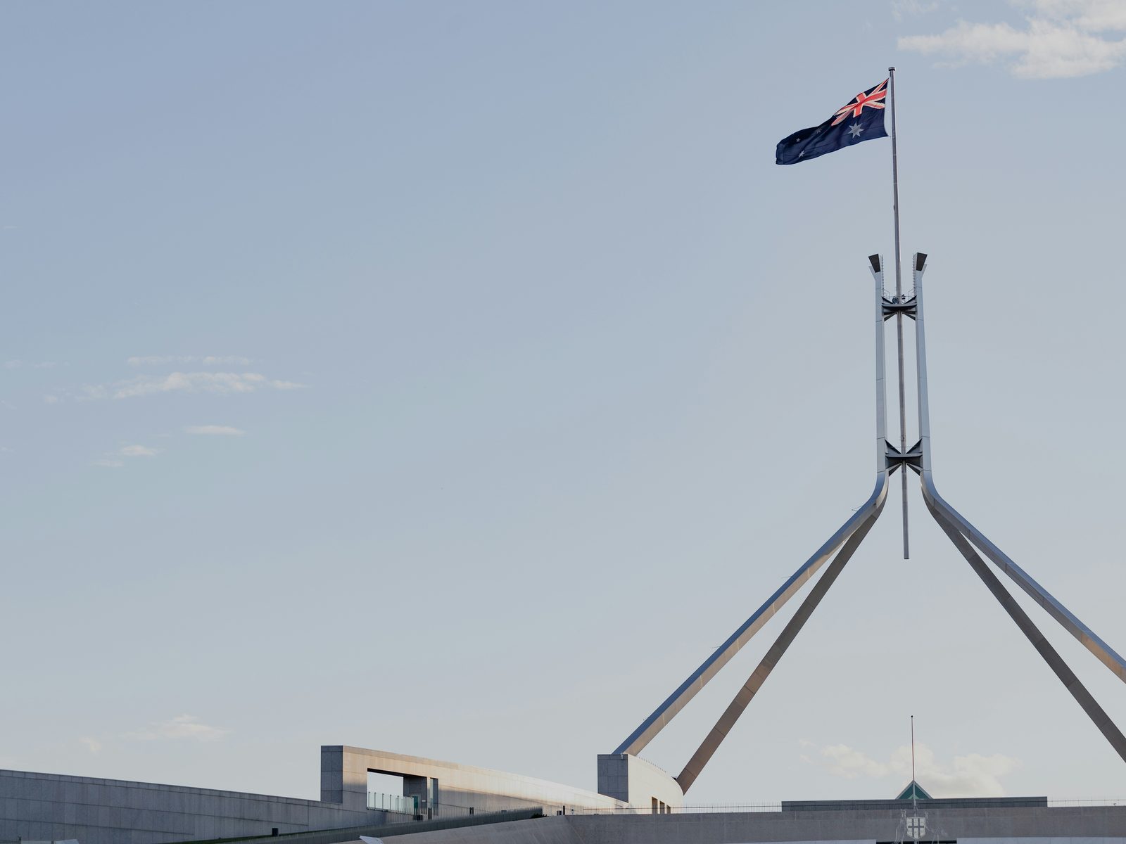 The flag above Parliament House, Canberra, against an evening sky